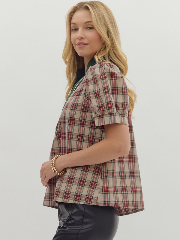 Woman wearing a plaid shirt against a plain background