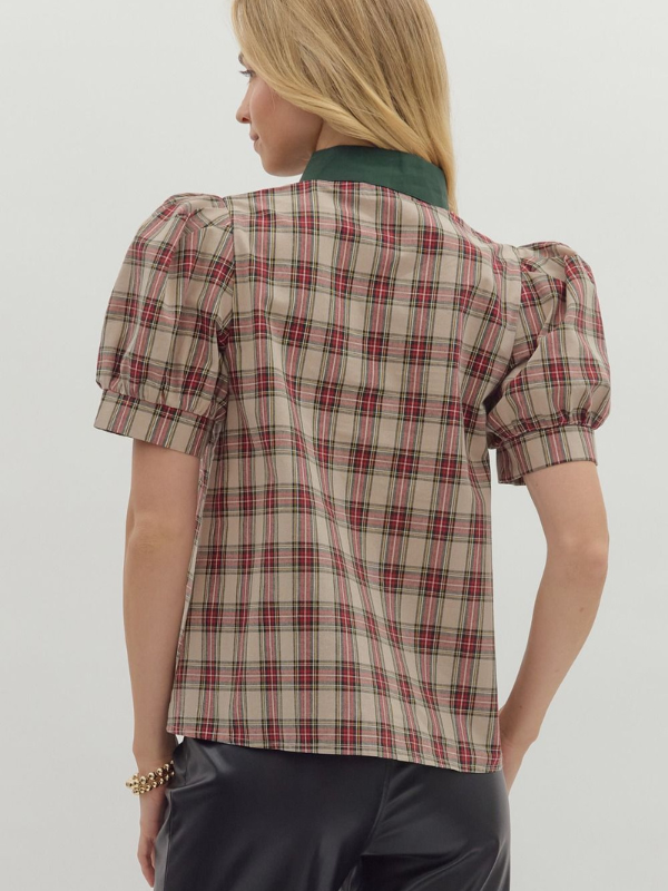 Woman wearing a plaid shirt with puff sleeves against a plain background