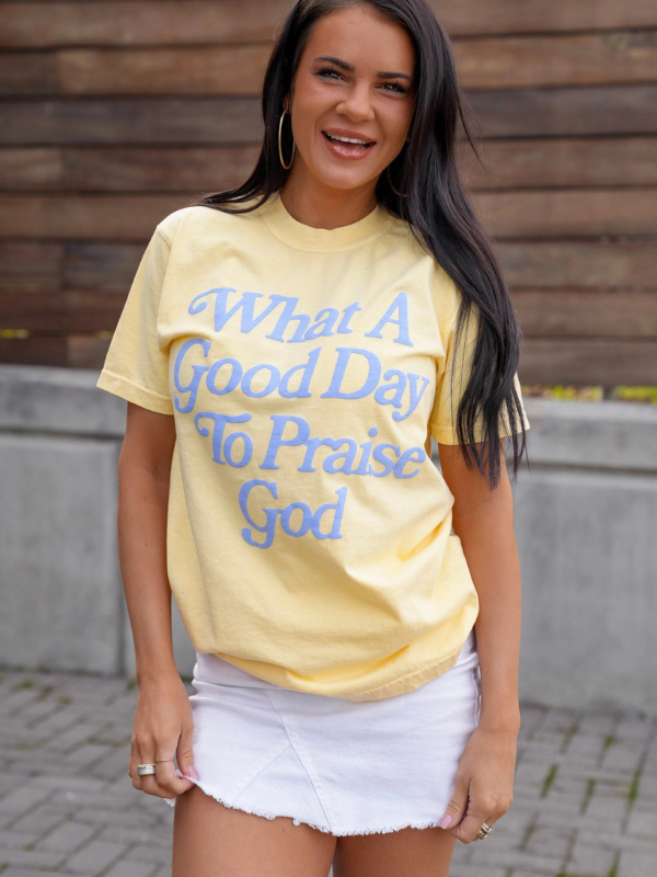 woman wearing yellow tee shirt that says what a good day to praise God 
