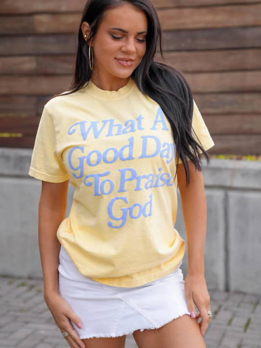 woman wearing yellow tee shirt that says what a good day to praise God 
