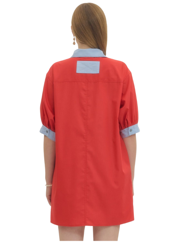 Red dress with blue collar and cuffs on a white background