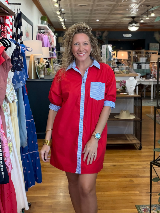 Woman wearing a red dress with blue accents in a store setting
