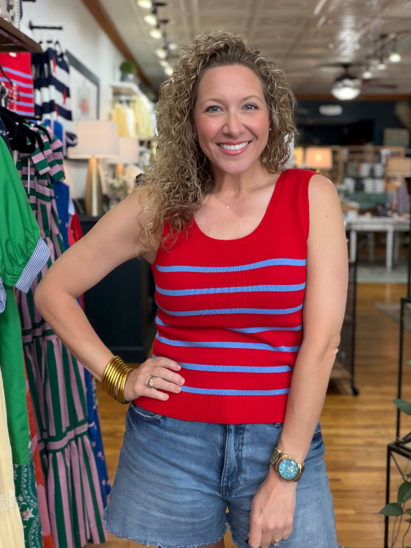 Woman wearing a red and blue striped tank top in a store setting
