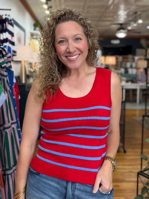 Woman wearing a red and blue striped tank top in a store setting