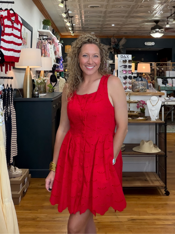 woman wearing a red dress in a boutique
