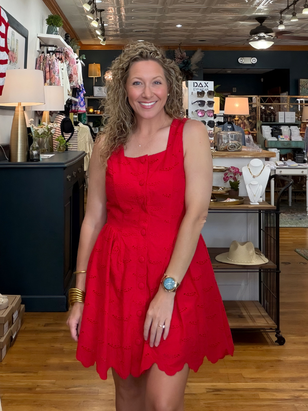 woman wearing a red dress in a boutique