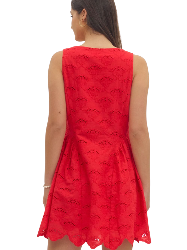 Red sleeveless dress with black pattern on a white background