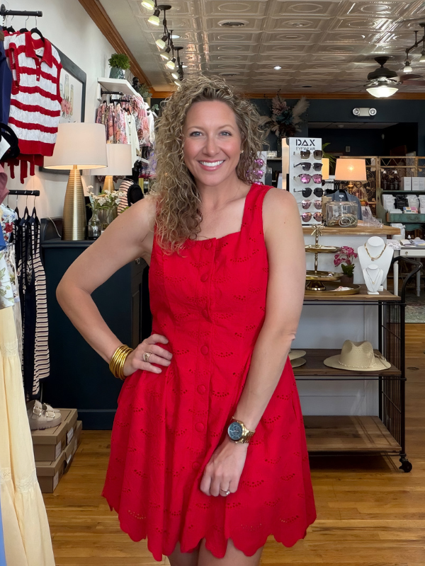 woman wearing a red dress in a boutique