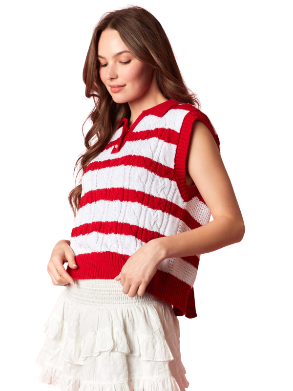 Woman wearing a red and white striped sleeveless sweater on a white background