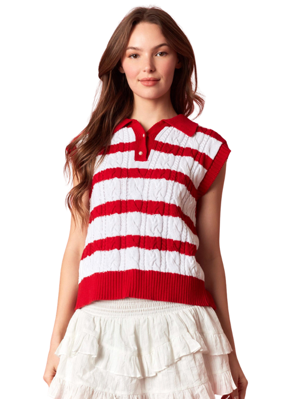 Woman wearing a red and white striped sleeveless sweater over a white dress on a white background