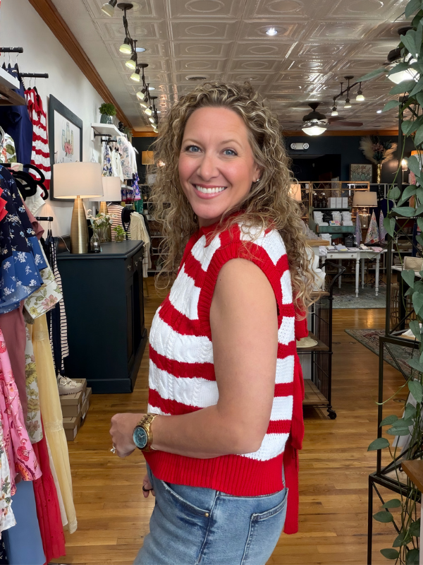 Woman wearing a red and white striped sweater in a store setting