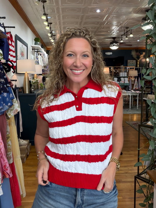 Woman wearing a red and white striped sleeveless sweater in a store setting