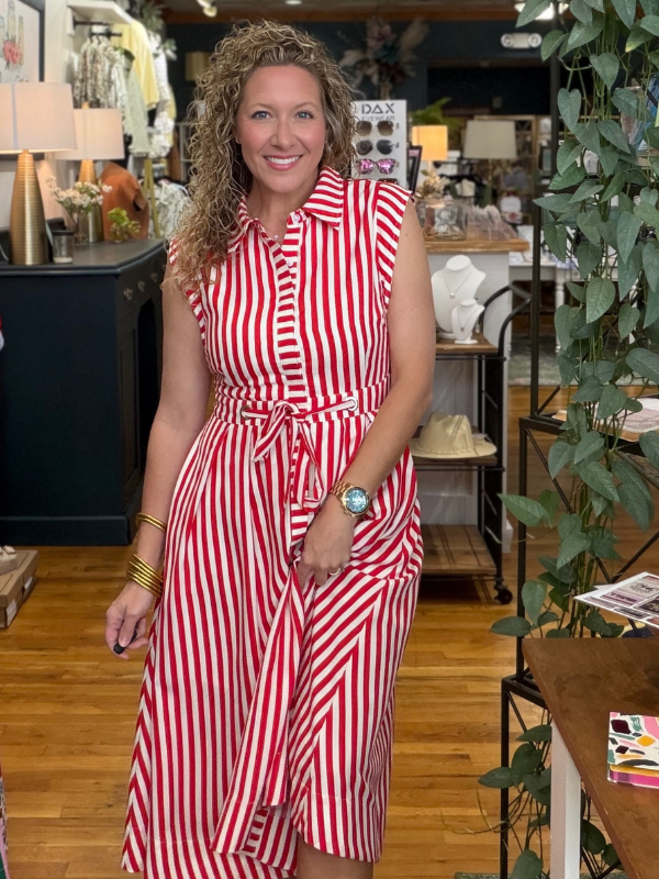 Woman in a red and white striped dress standing in a store.