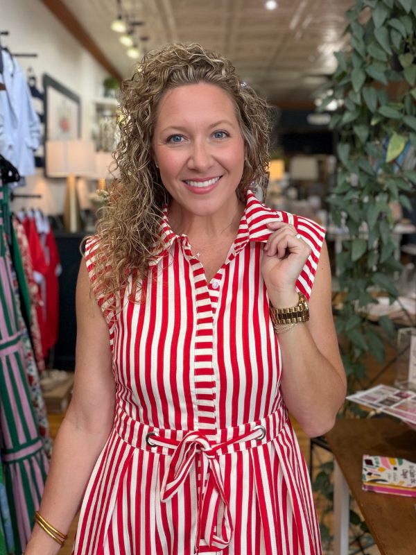 Woman wearing a red and white striped dress in a store setting