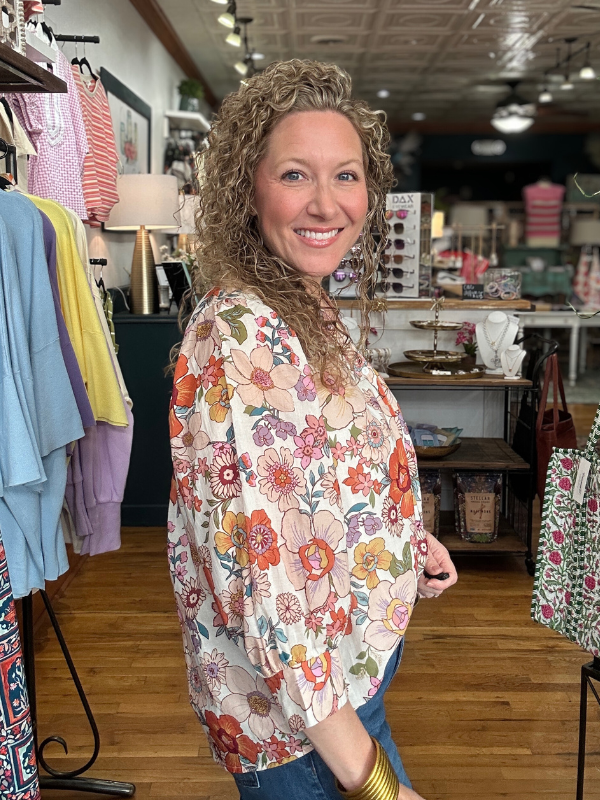 Woman wearing a floral shirt in a clothing store