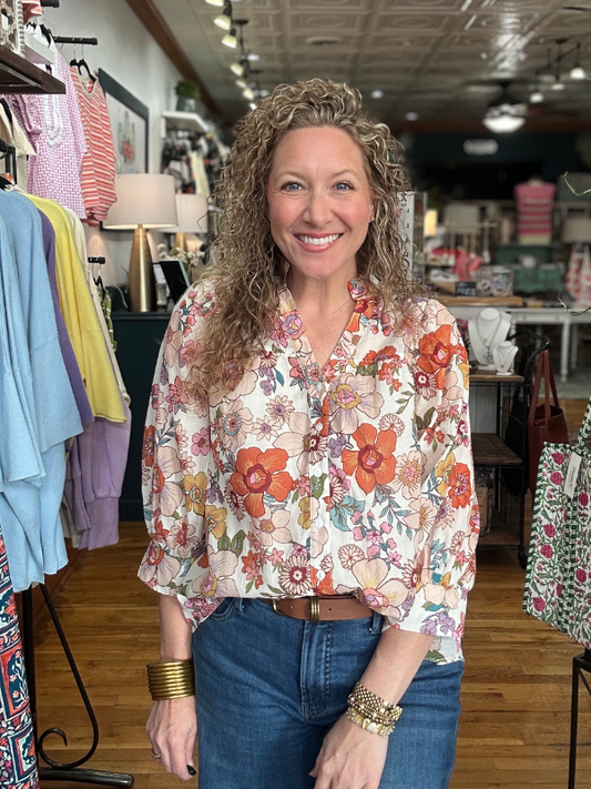 Woman wearing a floral blouse in a clothing store
