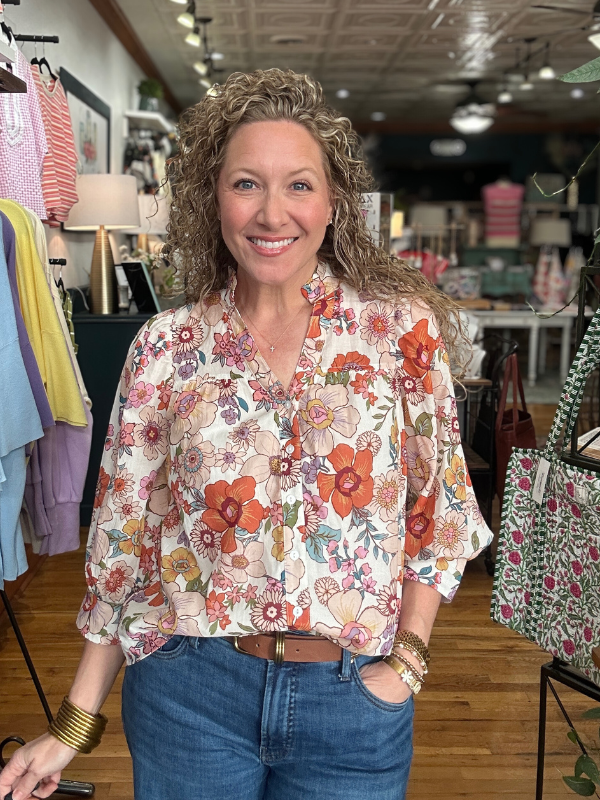 Woman wearing a floral blouse in a clothing store