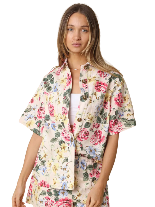 Woman wearing a floral kimono-style jacket on a white background