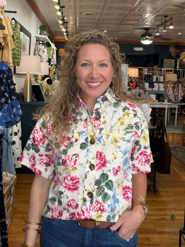 Woman wearing a floral shirt in a store setting