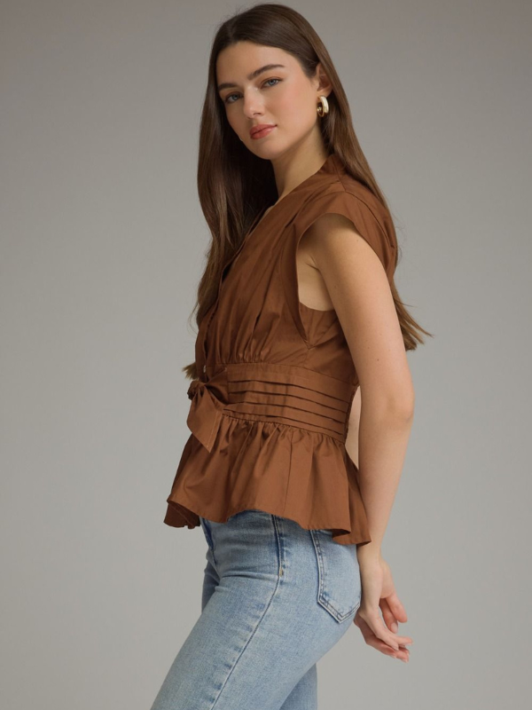 woman wearing a soft brown tie top with jeans 