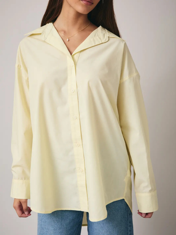 Light yellow shirt worn by a person on a plain background