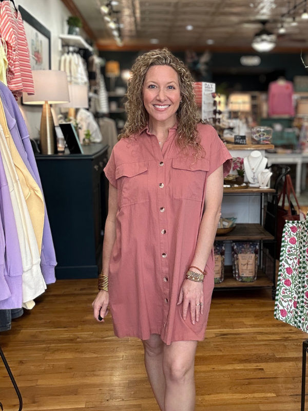 Woman wearing a pink dress in a store setting
