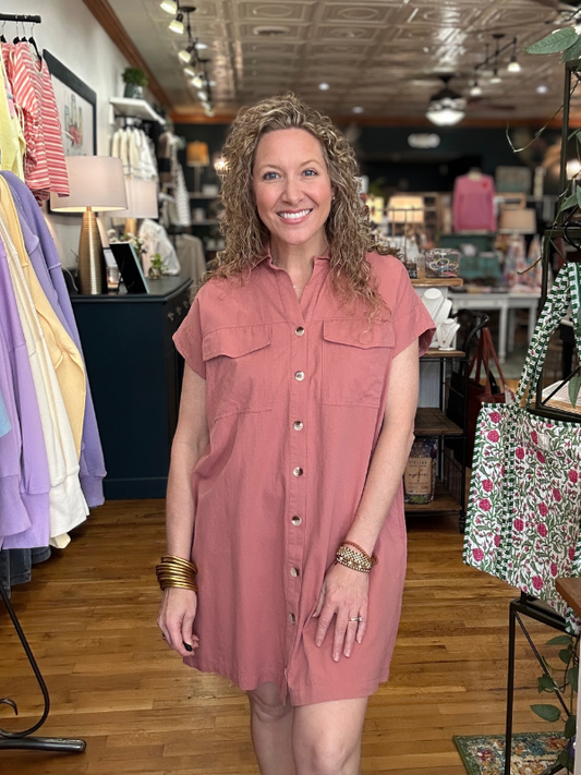 Woman wearing a pink dress in a store setting