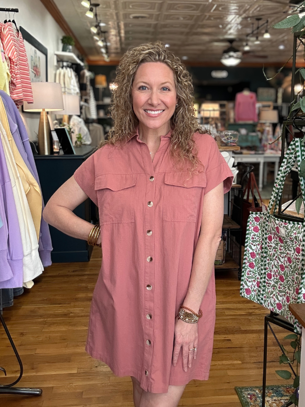 Woman wearing a pink dress in a clothing store