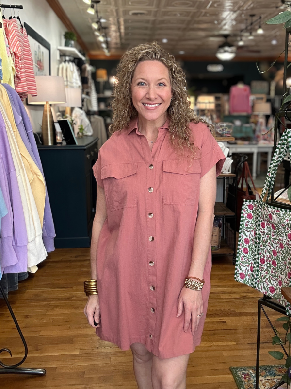 Woman wearing a pink dress in a clothing store