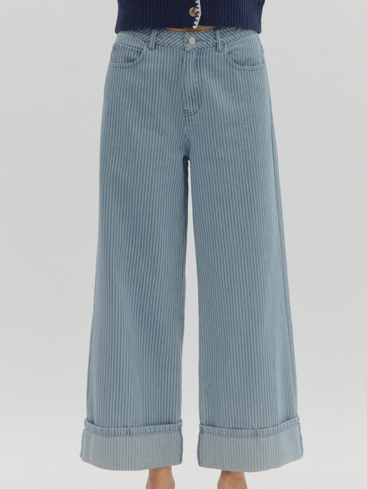 Light blue striped wide-leg pants on a light gray background