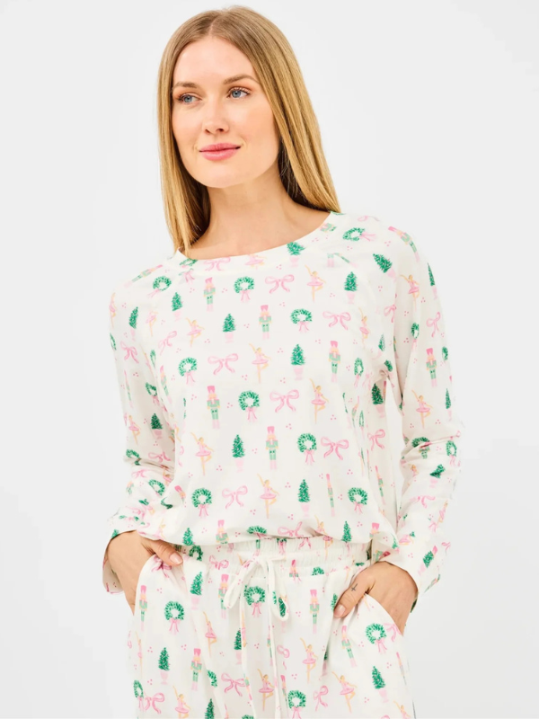 Woman wearing a long-sleeve dress with festive pattern on a white background