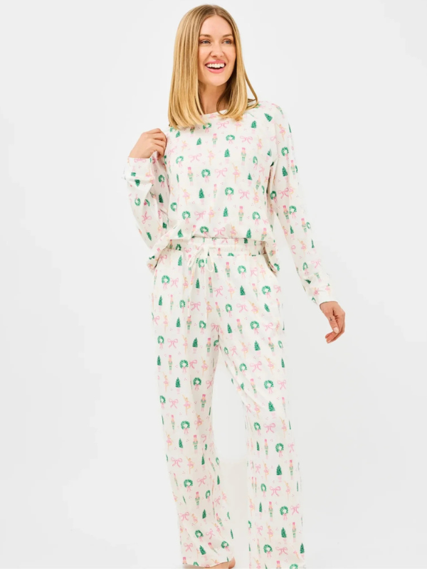 Woman wearing a floral pajama set on a white background