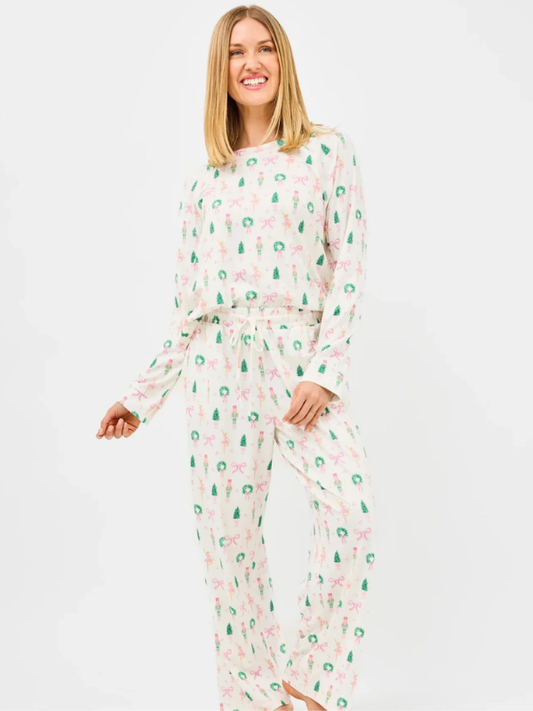 Woman wearing a floral pajama set on a white background