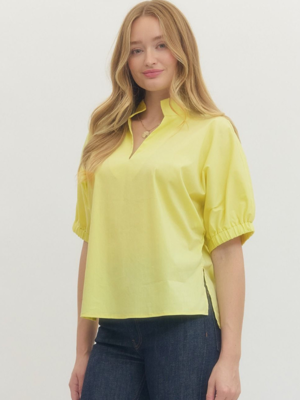 Woman wearing a yellow blouse with short sleeves on a white background