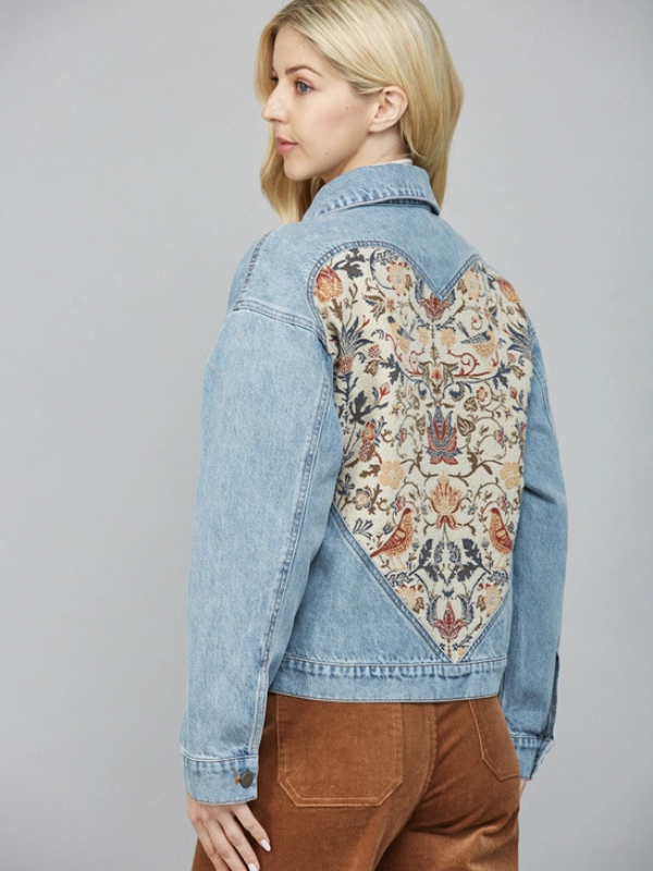 Denim jacket with floral embroidery on a gray background