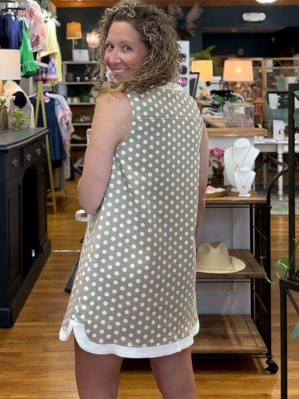 Woman wearing a polka dot dress in a store setting
