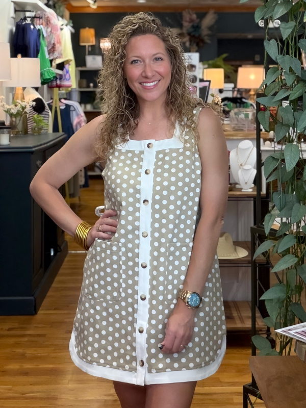 Woman wearing a polka dot dress in a store setting