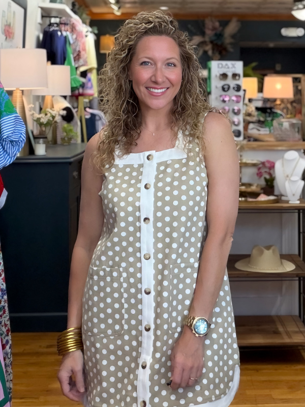 Woman wearing a polka dot dress in a store setting