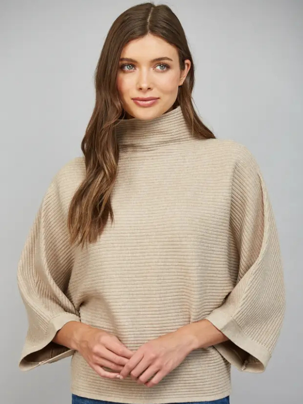 woman wearing a taupe horizontal textured ribbed sweater with jeans 