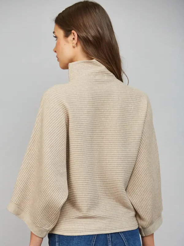 woman wearing a taupe horizontal textured ribbed sweater with jeans 
