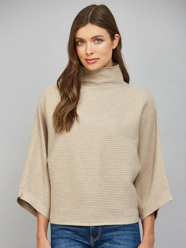 woman wearing a taupe horizontal textured ribbed sweater with jeans 