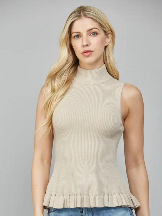 Woman wearing a beige sleeveless ribbed top against a gray background