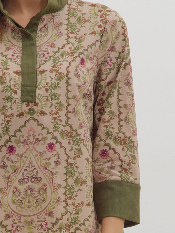 Beige kurta with green and pink floral patterns on a mannequin against a white background