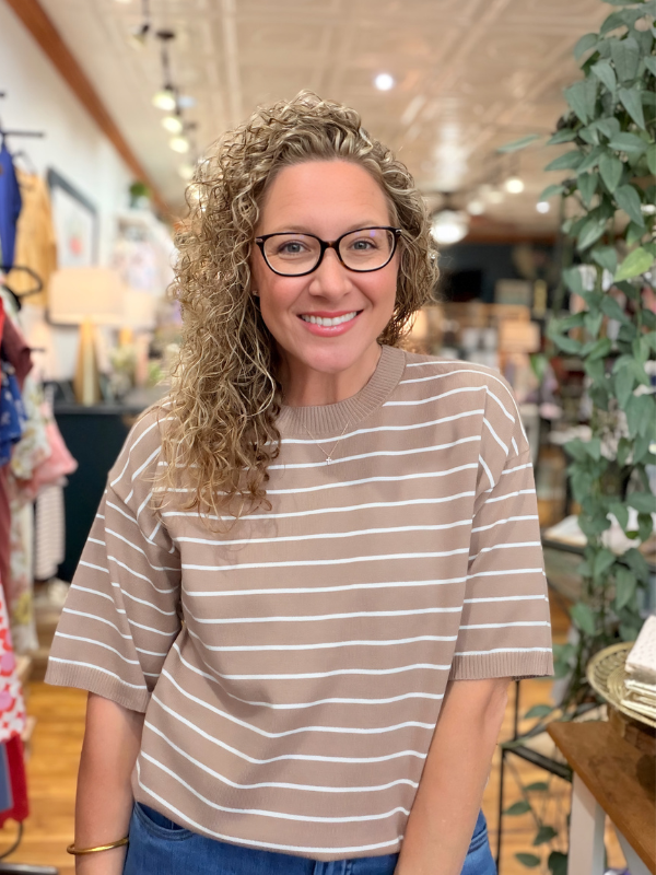 Woman wearing a striped shirt in a store setting