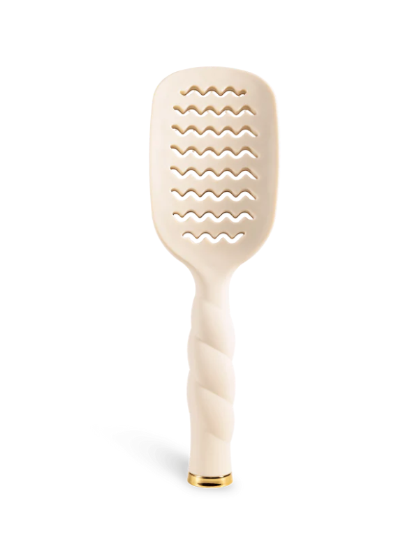 Beige paddle hair brush on a white background