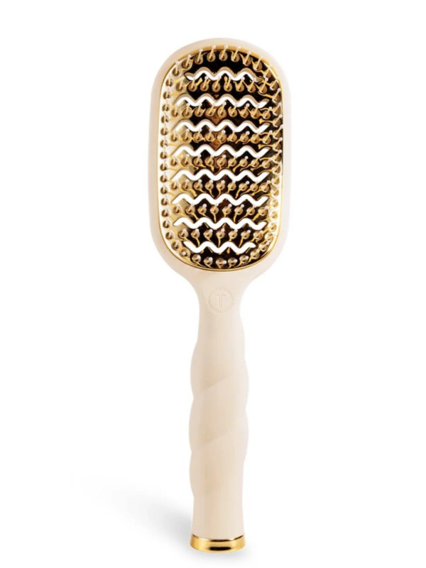 Beige paddle hair brush with gold accents on a white background