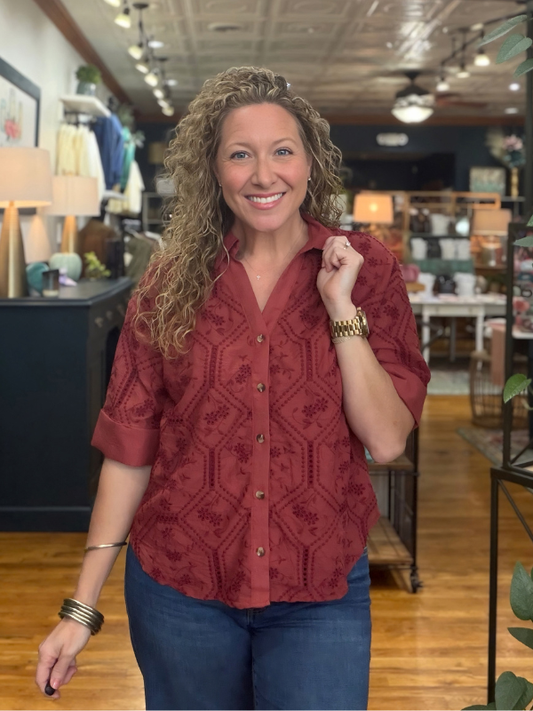 woman wearing a terra cotta button up collared top 