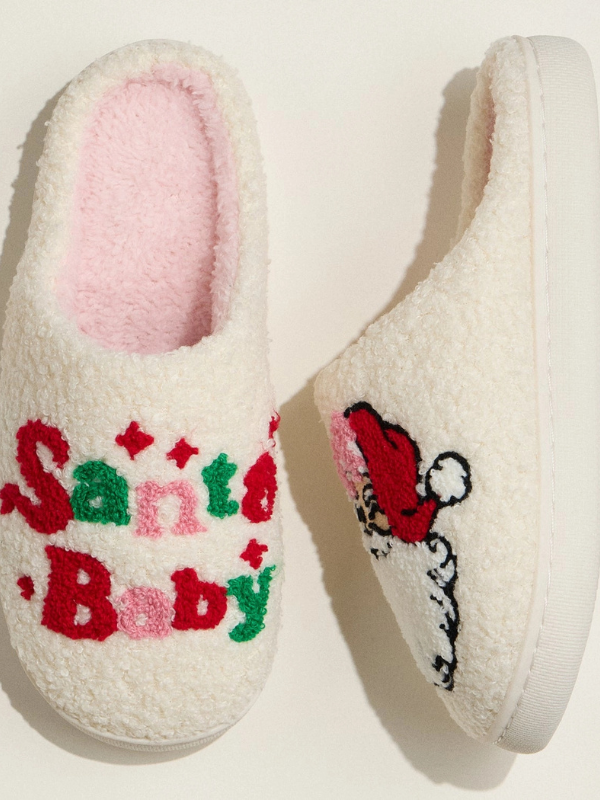 Pair of white slippers with 'Santa Baby' text and a Santa hat design on a light background