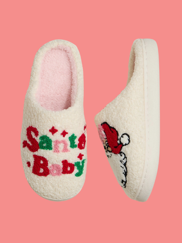 White slippers with 'Santa's Baby' text and Santa Claus design on a pink background
