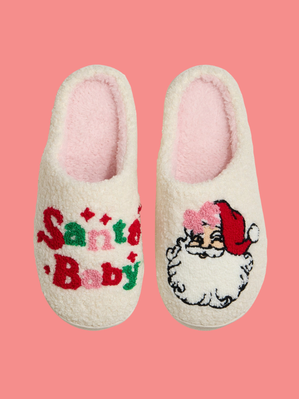 Pair of slippers with 'Santa's Baby' text and Santa Claus design on a pink background